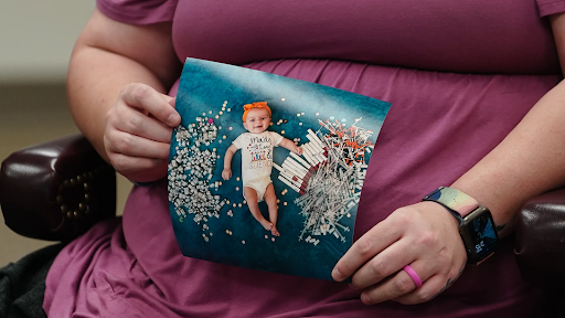 Photo: Elizabeth Goldman, an in-vitro fertilization patient at the University of Alabama at Birmingham, holds up a photo of her daughter who was born via the procedure.