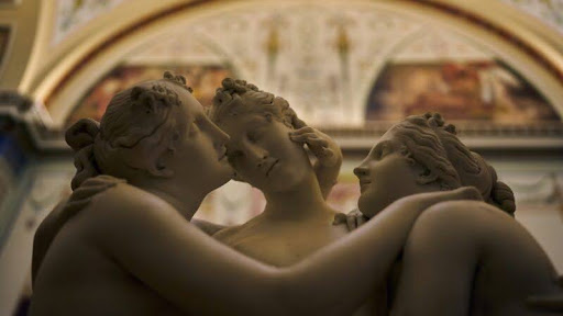Photo of a Roman statue of 3 feminine figures in an intimate position