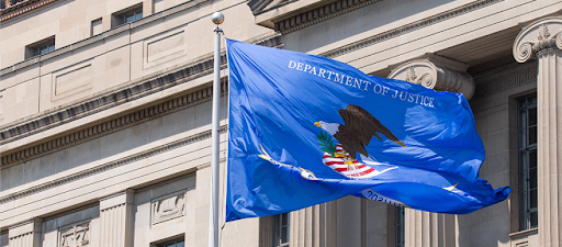 Photo of the flag of the Department of Justice blowing in the wind