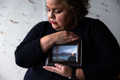 Sandra Muñoz, a celebrated civil rights attorney in Los Angeles, holds a photo of her husband Luis Asencio-Cordero on January 3, 2024, in Los Angeles, California.