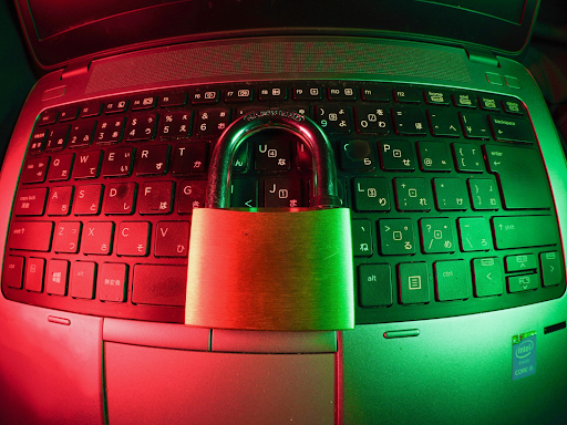 Photo of a laptop keyboard with a lock on top, green and red lighting
