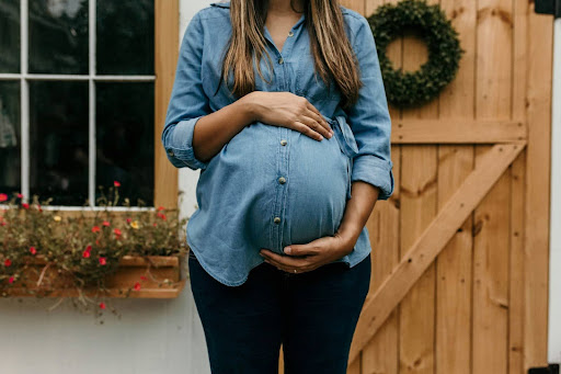 Photo of a pregnant person holding their belly.