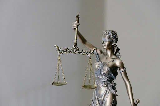 A photo of a metal Lady Justice statuette.