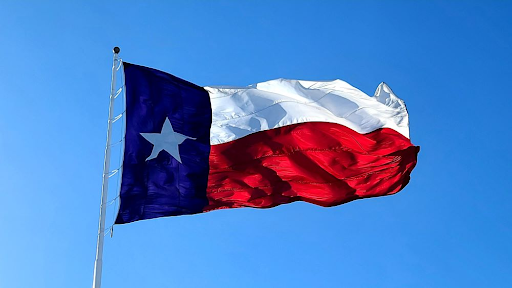 Photo of Texas state flag blowing in the wind.